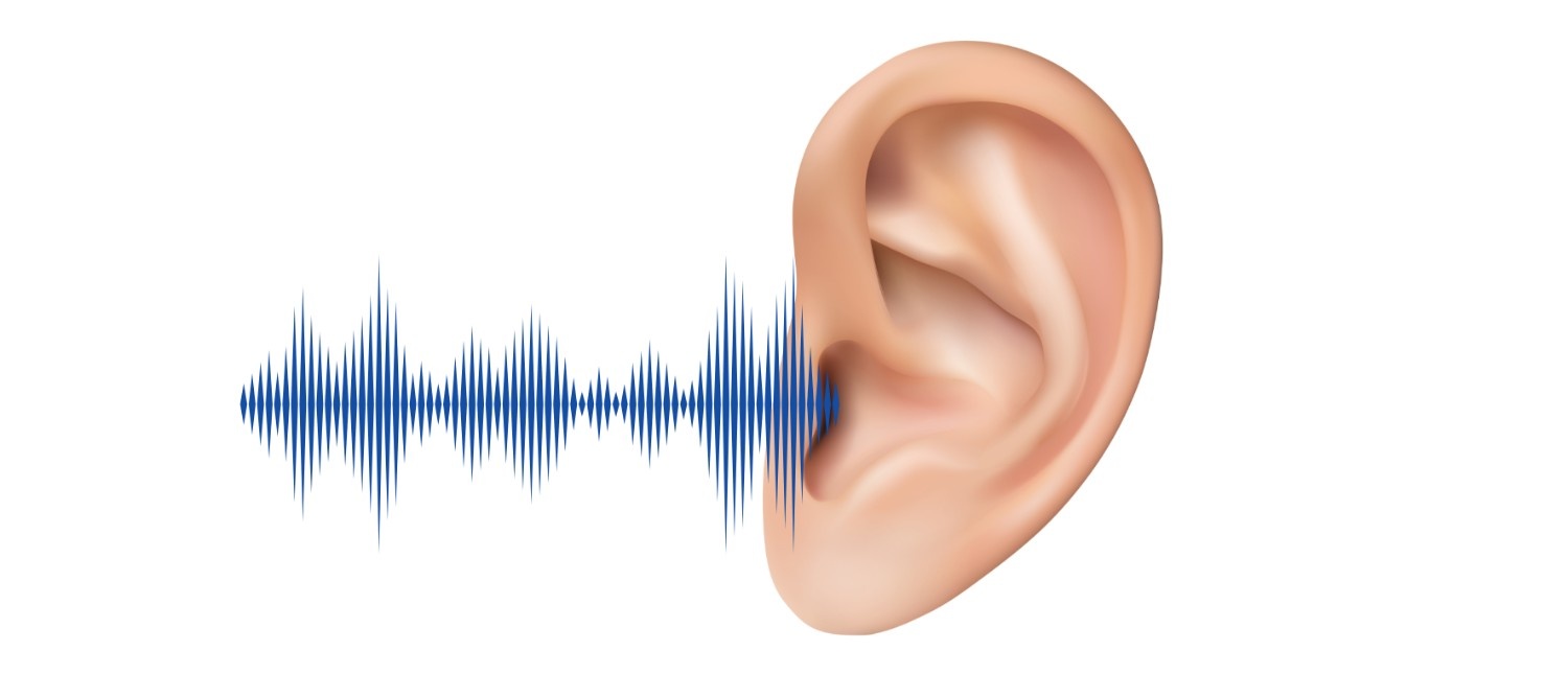 A person sitting quietly, unaware of surrounding sounds, illustrating early signs of Hearing Loss